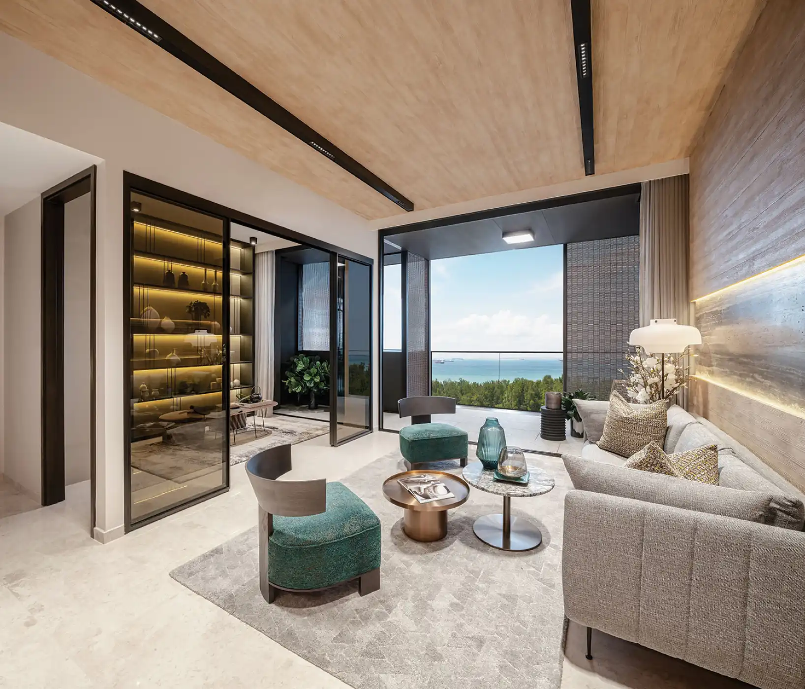 Contemporary living room with stylish furniture, warm lighting, and a view of the ocean through large windows. Features a neutral colour palette and comfortable seating.