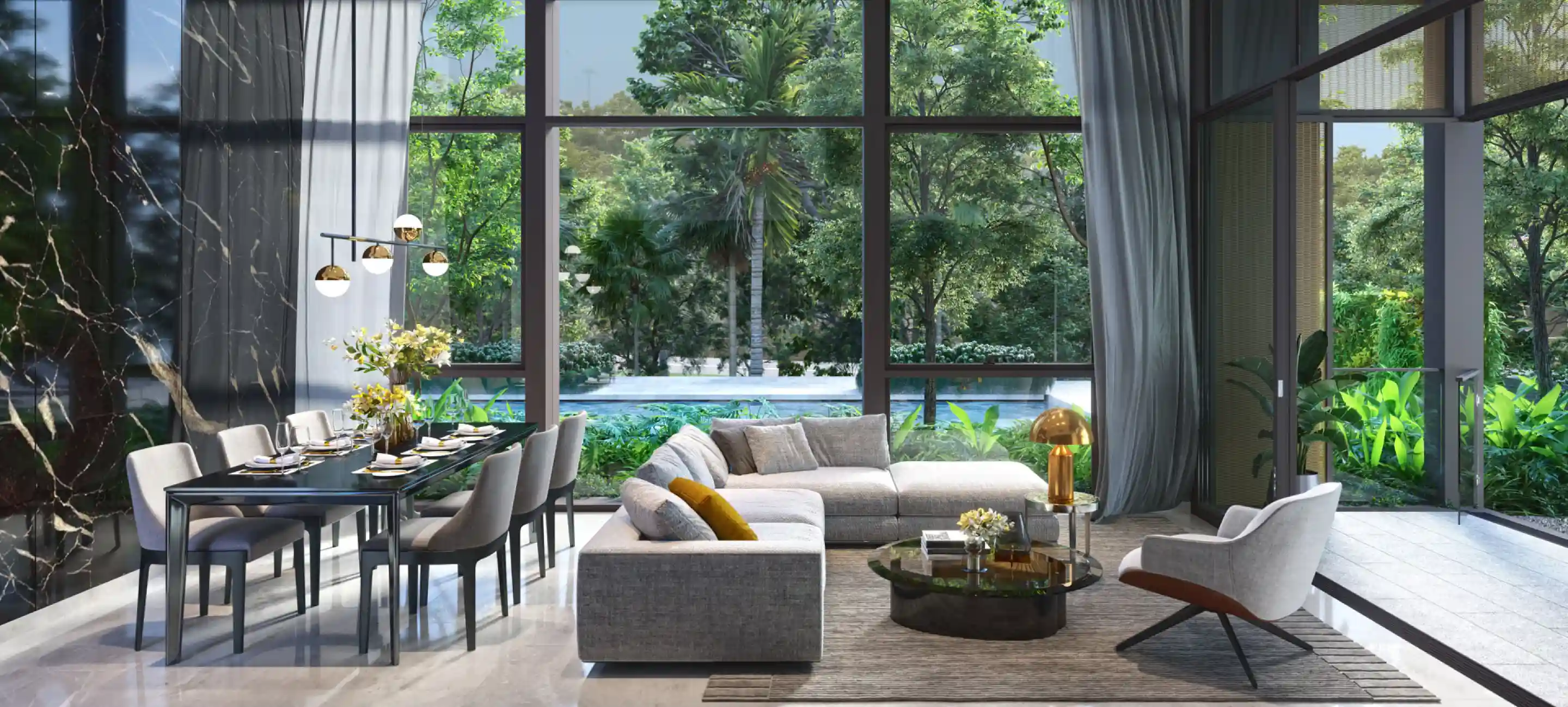 A chic and spacious living area with floor-to-ceiling windows that provide a view of tropical trees and greenery. The room is furnished with a gray sectional sofa, a round glass coffee table, and a modern dining setup, creating an airy, natural vibe.