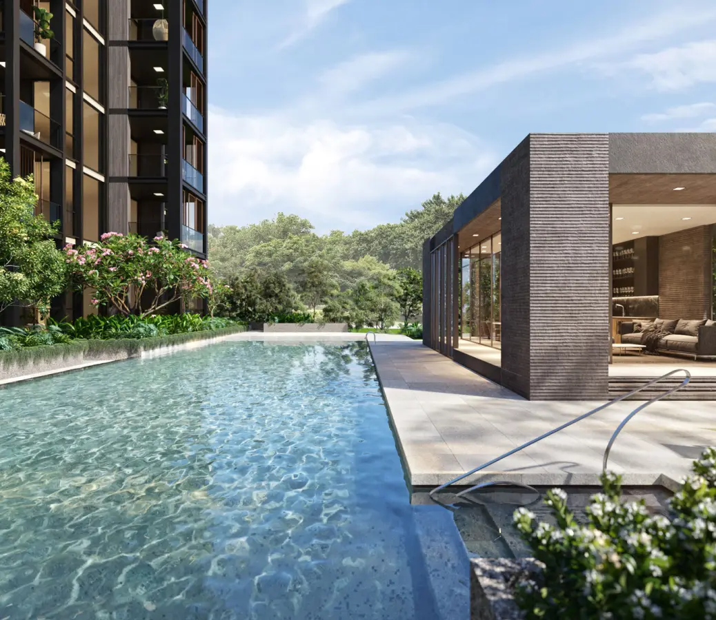 A serene swimming pool beside the clubhouse, surrounded by green foliage. The pool area includes a lounging area, offering a peaceful retreat amidst nature.